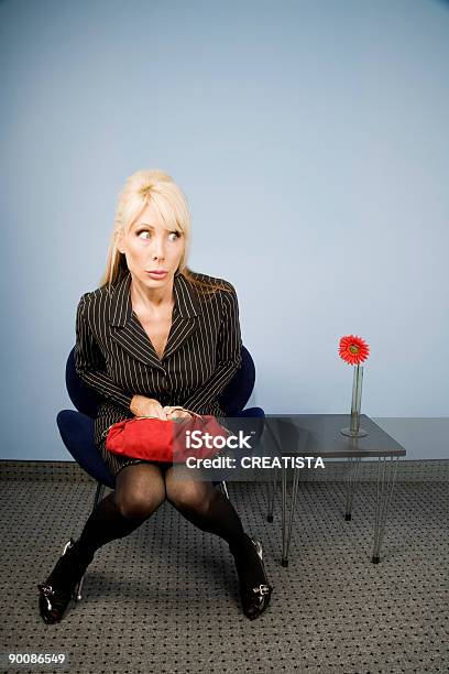 Apprehensive Woman Sitting Waiting In An Office Chair Stock Photo - Download Image Now
