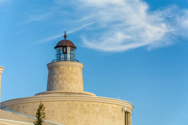 istock close up of Light house against blue sky 900868276