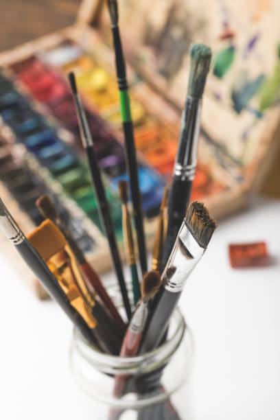 istock close-up selective focus on paint brushes and watercolor paints on white 900868304