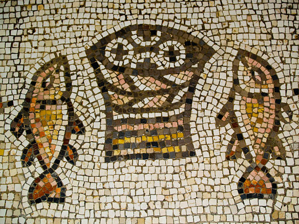 Ancient mosaic of fish in Tabgha, Israel Ancient mosaic inside the Church of the Multiplication of the Loaves and the Fishes, Tabgha, Israel galilee photos stock pictures, royalty-free photos & images