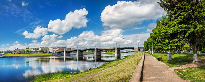 Novo-Volzhsky bridge across the Volga in Tver and embankment under white clouds in the blue sky