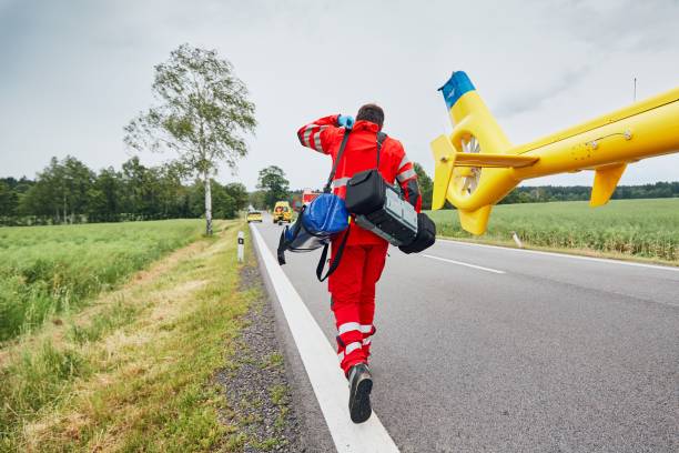 Helicopter emergency medical service Doctor with defibrillator and other equipment running from helicopter. Teams of the Emergency medical service are responding to an traffic accident. helicopter stock pictures, royalty-free photos & images