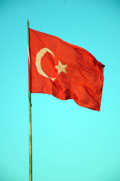 istock Turkish Flag waving in blue sky 900873560