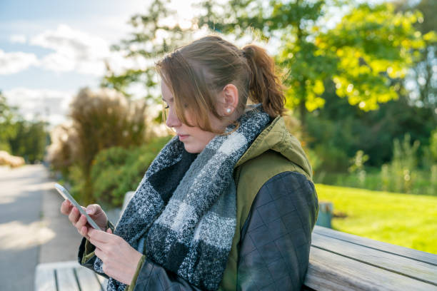 istock A woman with cellphone is writing a text message 900873682