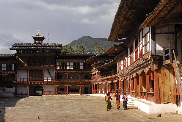 People & Pigeons in Dzong courtyard stock photo