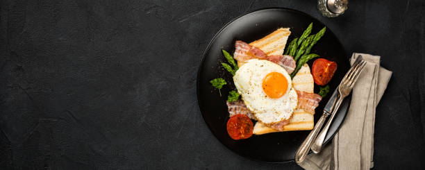 jajko sadzone z tostami chlebowymi i szparagami - breakfast eggs plate bacon zdjęcia i obrazy z banku zdjęć