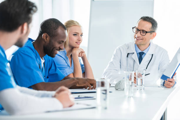 istock team of doctors having conversation 900875720