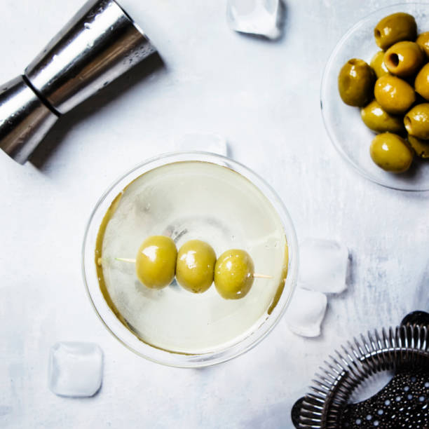 Classic alcoholic cocktail with dry vermouth and green olives