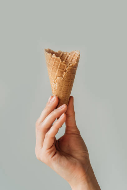 istock woman holding ice cream cone 900880880