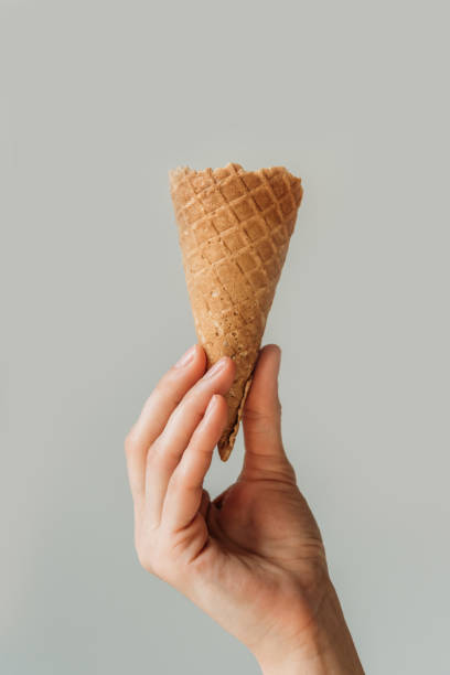 istock woman holding ice cream cone 900881002