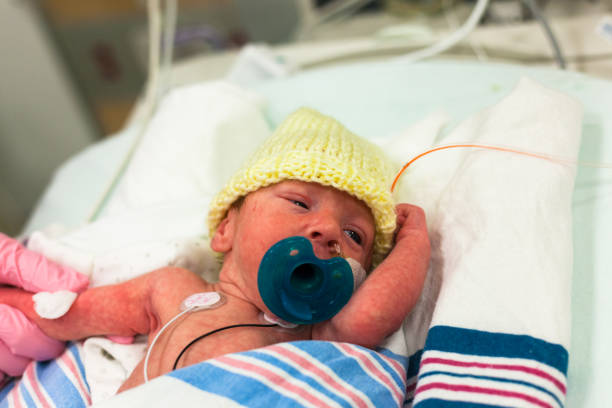 istock Premature baby in the neonatal intensive care unit with a pacifier 900881030