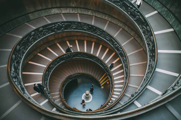 Rome, Italy - December 19th, 2015: The famous and old spiral staircase. that leads to the exit of the vatican museum inside the vatican city. The Vatican Museums are among the greatest museums in the world.