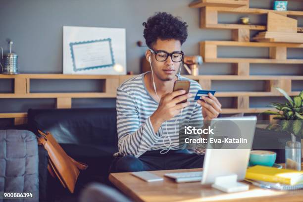 Young Man Working At Home Office Stock Photo - Download Image Now - Online Shopping, Credit Card, Men