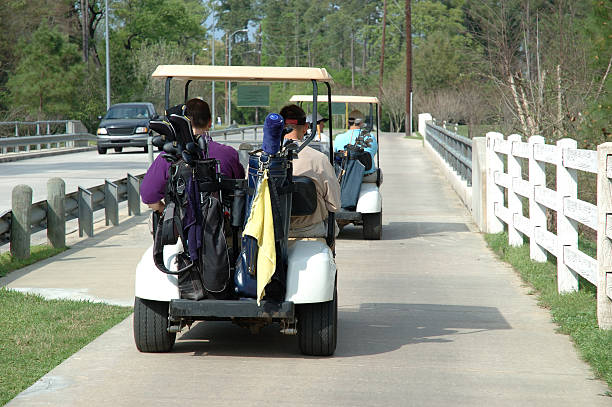 istock Golfers In Golf Carts Between Holes Going Across Bridge 90088837