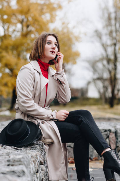 istock woman talking by phone in park 900890232