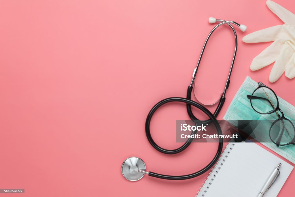 Flat lay aerial of accessories healthcare & medical background concept.Free space for mock up & template.Difference objects on modern rustic pink paper.An idea for essential tools doctor in hospital. Doctor Stock Photo
