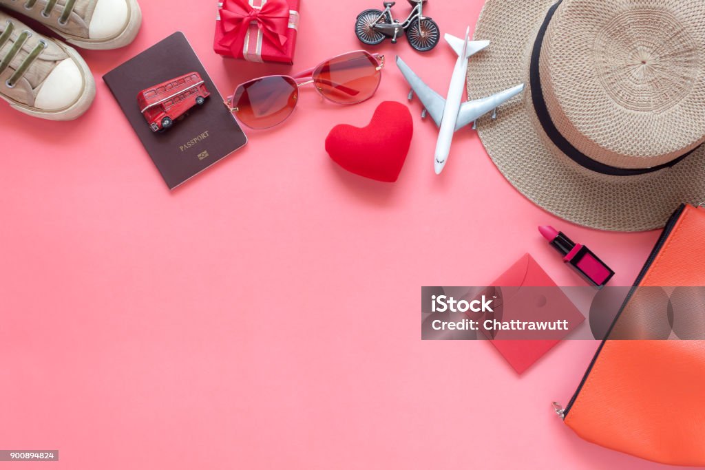 Flat lay image of accessory clothing women to plan travel in valentine's day background concept.Essential items for traveler & backpacker adult or teenage to holidays trip.Space for creative design. Flat Lay Stock Photo