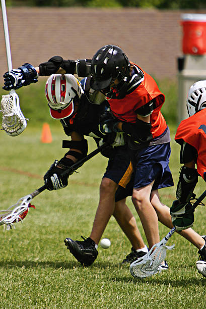 istock Two Lacrosse Players Battle in Tangled Scramble 90089922