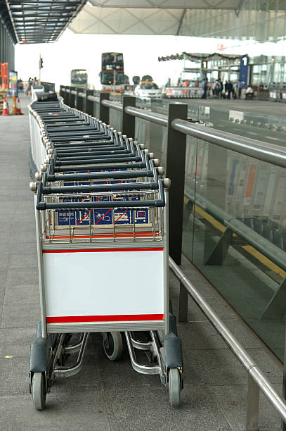 istock Row of luggage carts with blank billboard 90089944