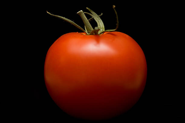 Ripe Red Tomato on Black stock photo