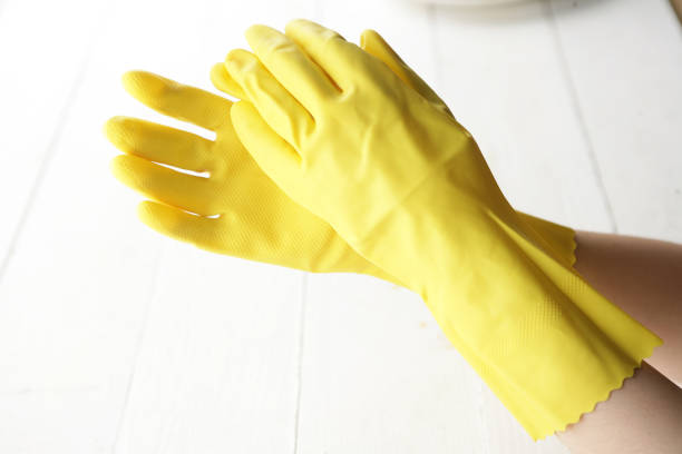 istock Hands in yellow gloves 900901480