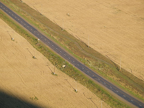 istock Road across field with telegraph pole without car. 90090270