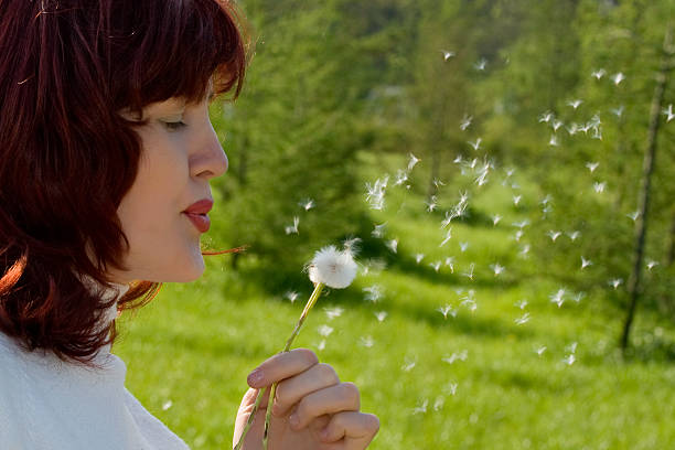 istock Woman Blowing to Dandelion 90090604
