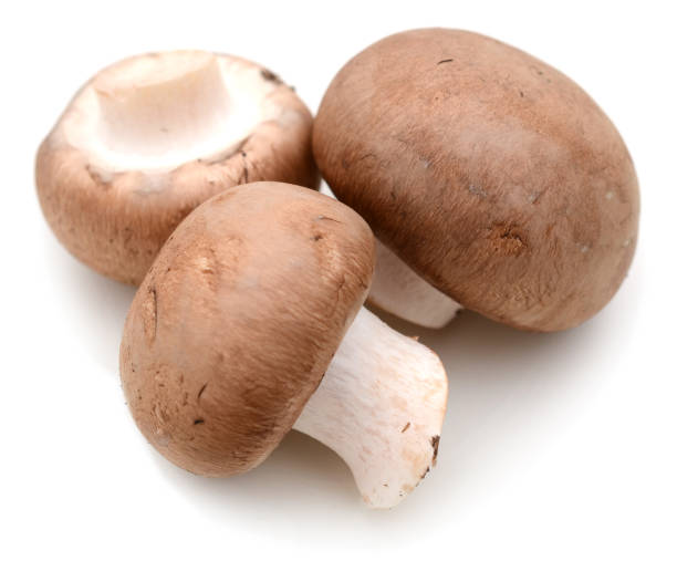 istock Heap of raw white champignons isolated on white 900906180