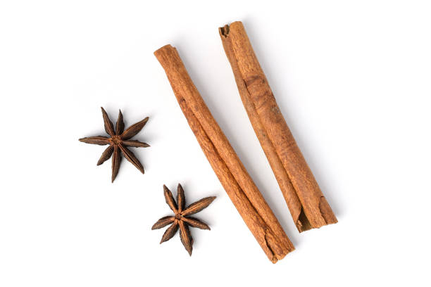 istock Two brown vegetarian cinnamon sticks lying on white background 900911654