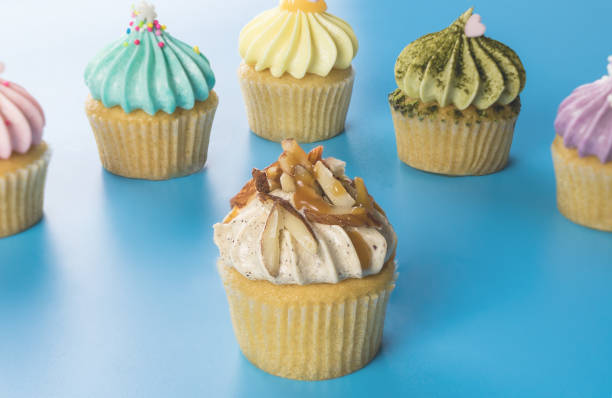 istock Caramel and nut mini cupcake with colorful cupcake on the background 900911724