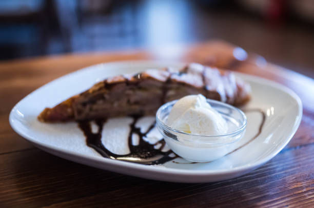 istock Apple strudel with vanilla ice cream partially blurred during shooting 900911840