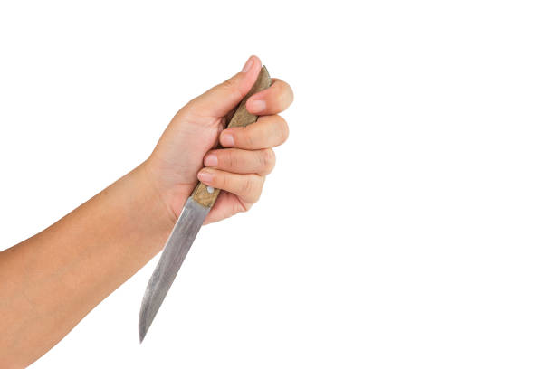 istock hand holding knife on white background.Suicide concept. 900917198