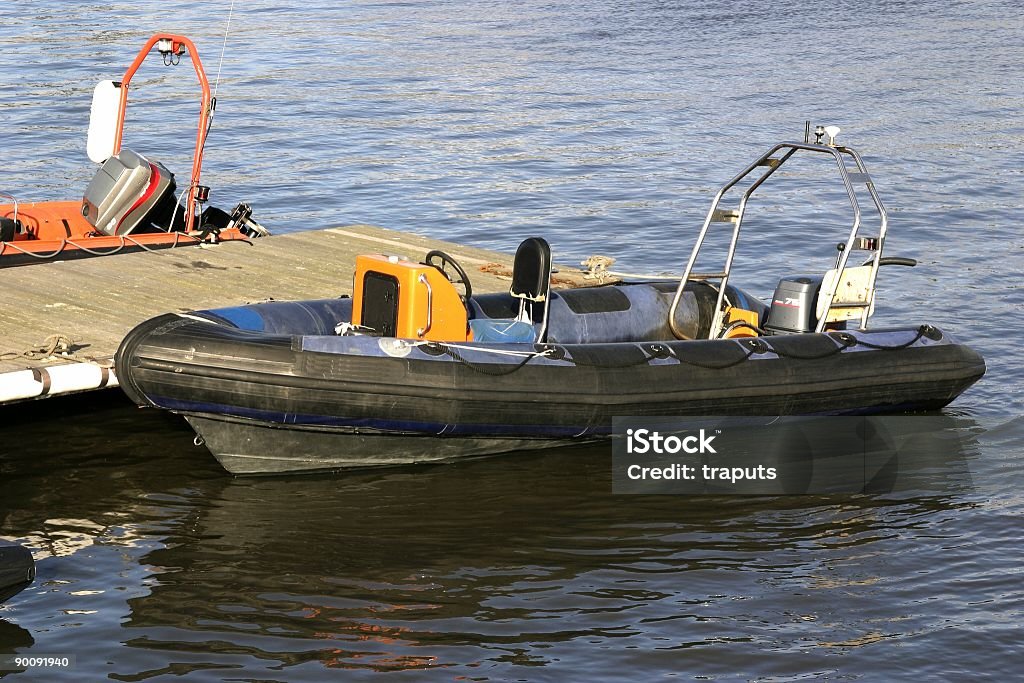 Moored Inflatable Rubber Boat tied to jetty  Aquatic Sport Stock Photo