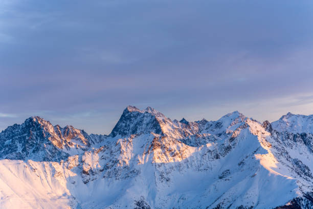 istock Glowing snowy mountains during sunset in the alps 900921090