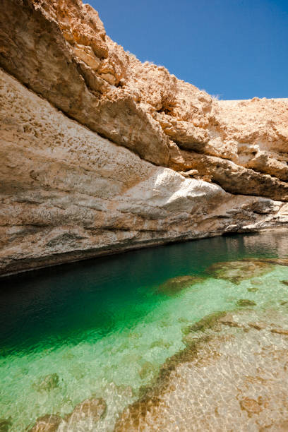 istock bimmah sinkhole, geological depression in the limestone, oman 900921662