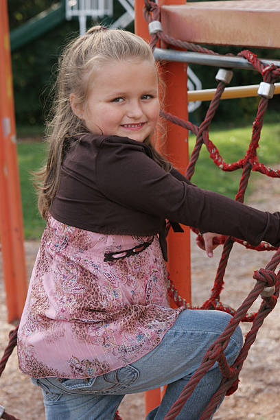 istock Young girl climbing rope ladder 90092182