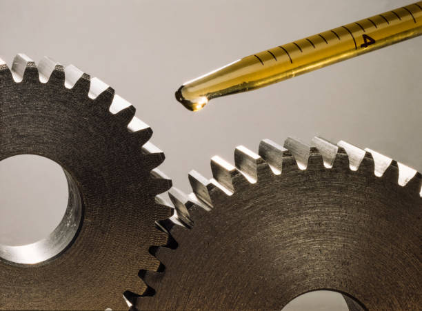Lubricating two pinions with a few drops of oil Lubricating two pinions with a few drops of oil. Mechanical sprockets lubrication stock pictures, royalty-free photos & images