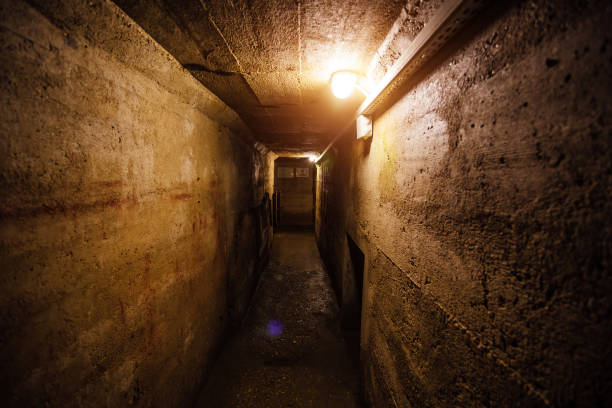 istock Dark corridor of old underground Soviet bunker under military artillery fortification 900925218