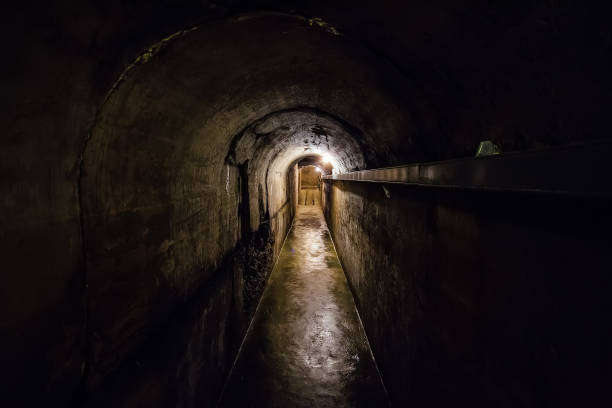istock Dark corridor of old underground Soviet bunker under military artillery fortification 900925310