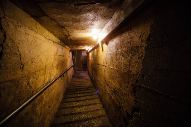 istock Dark corridor of old underground Soviet bunker under military artillery fortification 900925378