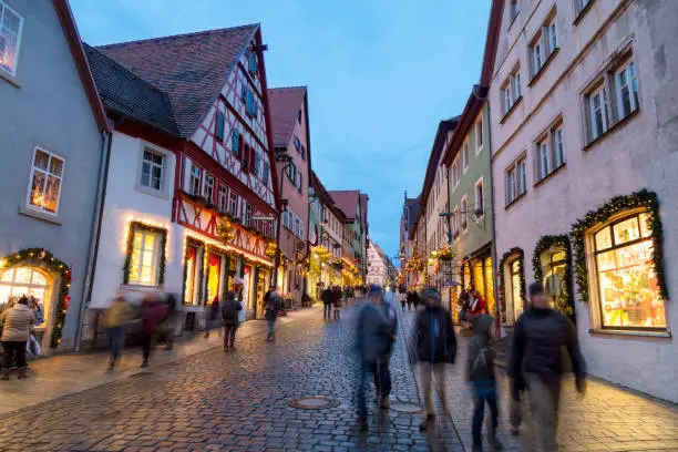 Photo of People Walking in Decorated Street for Christmas, Rothenburg at Dusk, Germany