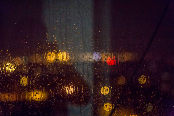 istock Water drop texture on window, City at night 900932978