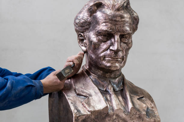 Sculptor working. Adding the finishing touches to the bust of a male figure. bronze statue stock pictures, royalty-free photos & images