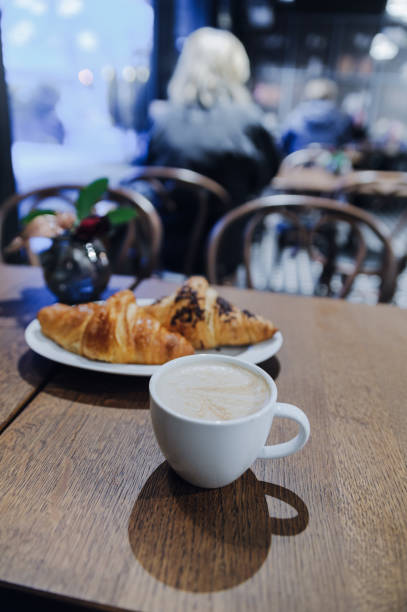 istock Cup of coffee cappuccino with two croissants 900933782