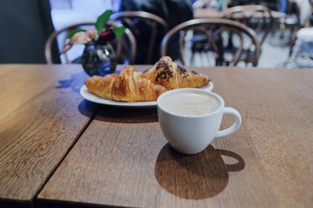 istock Cup of coffee cappuccino with two croissants 900933794