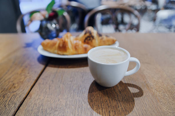 istock Cup of coffee cappuccino with two croissants 900933832