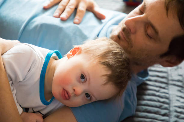 istock Cute baby boy with Down syndrome with dad 900937900