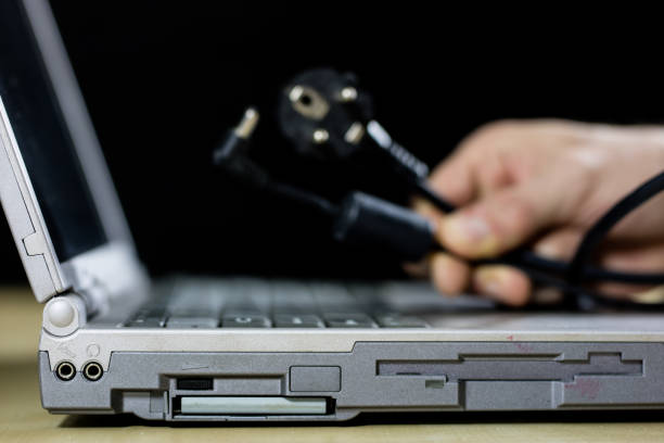 istock A laptop on a wooden table seen from the profile together with carpentry tools. Computer repair in a workshop. Black background. 900938222