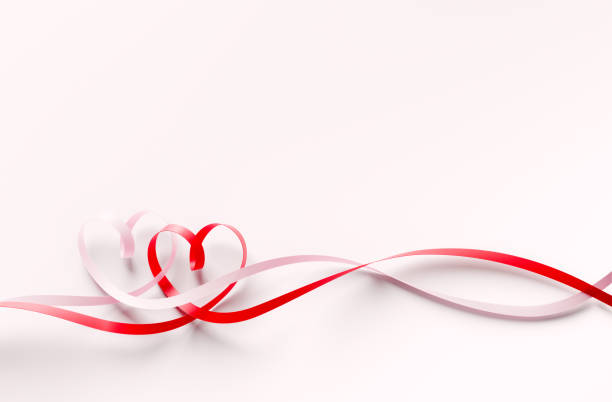 Valentines Day concept. Heart shaped ribbons tangled on white background. Horizontal composition with  and copy space. Clipping path is included.