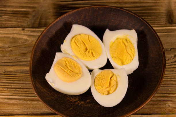 istock Boiled eggs on a plate on wooden table 900942804